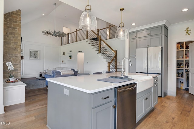 447 Marcellus Way, Clayton, NC 27527 - kitchen with gray cabinets, dishwasher, open floor plan, light wood finished floors, and high vaulted ceiling
