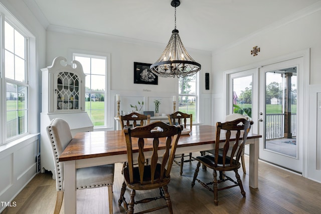 447 Marcellus Way, Clayton, NC 27527 - dining space featuring a decorative wall, crown molding, a chandelier, wood finished floors, and a wainscoted wall