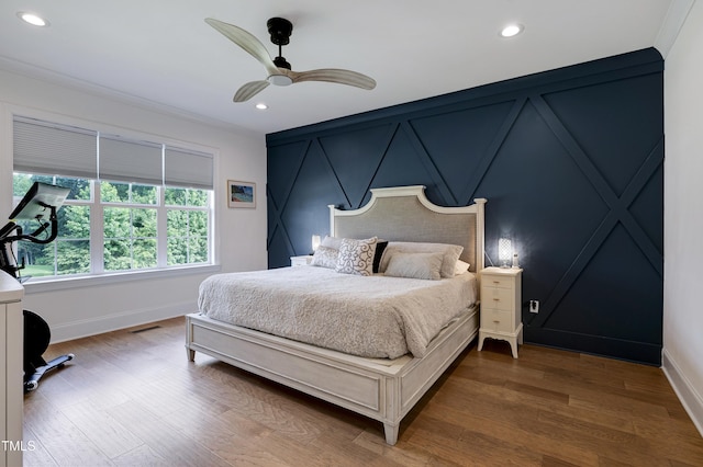 447 Marcellus Way, Clayton, NC 27527 - bedroom featuring a decorative wall, wood finished floors, recessed lighting, and a ceiling fan