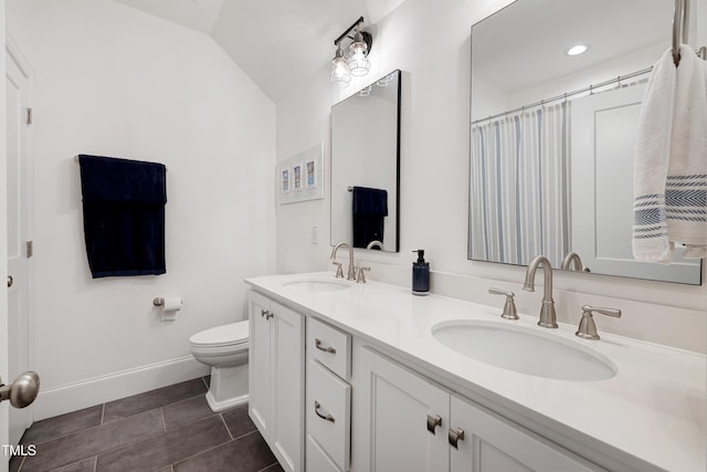 447 Marcellus Way, Clayton, NC 27527 - full bathroom featuring double vanity, tile patterned floors, and vaulted ceiling