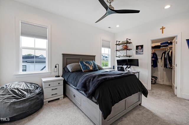 447 Marcellus Way, Clayton, NC 27527 - bedroom with light carpet, multiple windows, a spacious closet, recessed lighting, and ceiling fan
