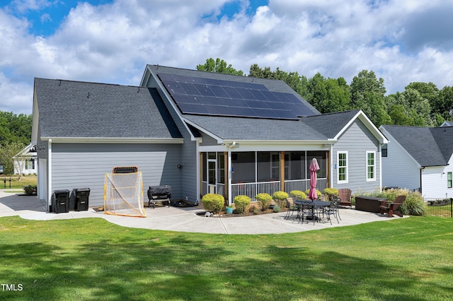 447 Marcellus Way, Clayton, NC 27527 - rear view of property featuring a patio, a sunroom, roof mounted solar panels, and a lawn