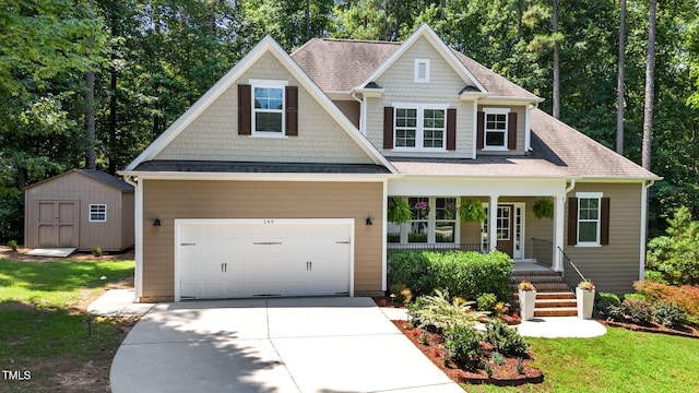 149 Hadley Ln, Clayton, NC 27527 - craftsman-style house featuring covered porch, driveway, a garage, a storage unit, and a shingled roof