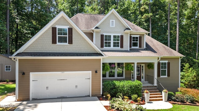 149 Hadley Ln, Clayton, NC 27527 - craftsman house with concrete driveway, covered porch, a shingled roof, and an attached garage