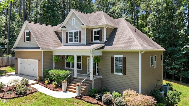 149 Hadley Ln, Clayton, NC 27527 - view of front of house with a porch, concrete driveway, roof with shingles, and a garage