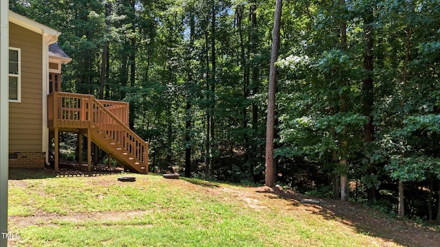 149 Hadley Ln, Clayton, NC 27527 - view of green lawn featuring stairway, a wooden deck, and a view of trees