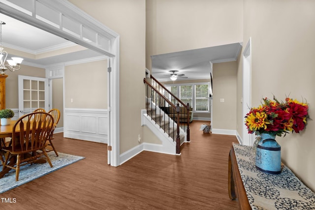 149 Hadley Ln, Clayton, NC 27527 - entrance foyer featuring wood finished floors, a chandelier, ornamental molding, stairway, and a ceiling fan