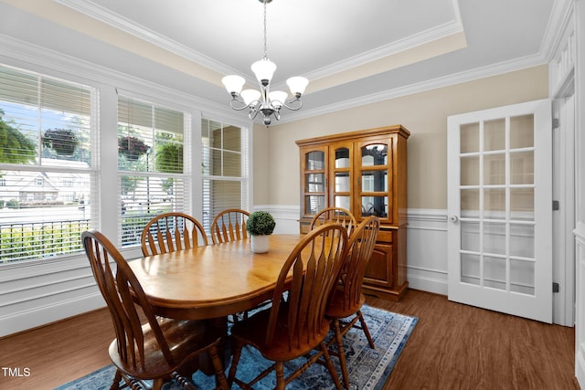 149 Hadley Ln, Clayton, NC 27527 - dining area with a chandelier, plenty of natural light, a wainscoted wall, wood finished floors, and crown molding