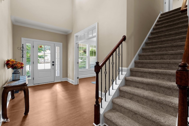 149 Hadley Ln, Clayton, NC 27527 - entrance foyer with stairs, a towering ceiling, wood finished floors, and ornamental molding