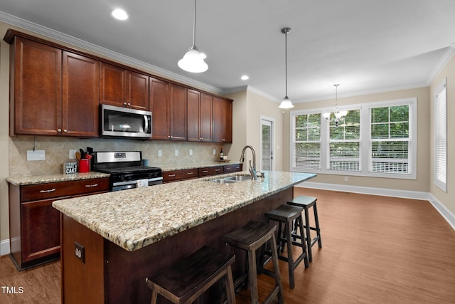 149 Hadley Ln, Clayton, NC 27527 - kitchen with stainless steel appliances, dark wood-type flooring, ornamental molding, backsplash, and an island with sink