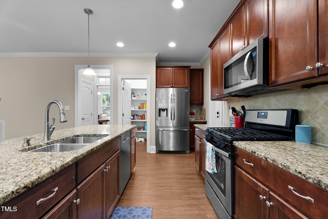 149 Hadley Ln, Clayton, NC 27527 - kitchen featuring appliances with stainless steel finishes, ornamental molding, backsplash, wood finished floors, and light stone counters