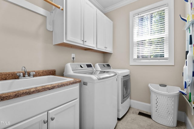 149 Hadley Ln, Clayton, NC 27527 - laundry room with washer and dryer, cabinet space, ornamental molding, and healthy amount of natural light