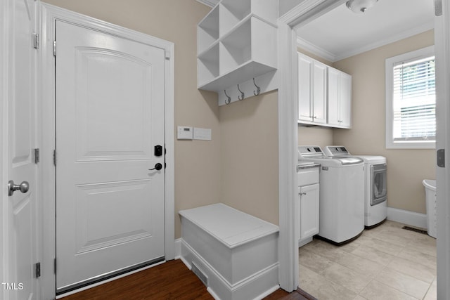 149 Hadley Ln, Clayton, NC 27527 - laundry room with ornamental molding, washing machine and clothes dryer, and cabinet space