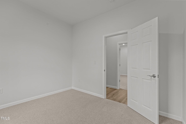 112 Edgewood Dr, Roxboro, NC 27573 - spare room featuring light colored carpet and baseboards
