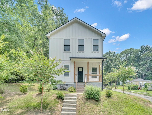 1213 Grant St, Durham, NC 27701 - view of front of house with board and batten siding, covered porch, and crawl space