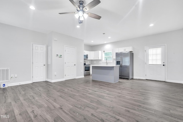 1213 Grant St, Durham, NC 27701 - unfurnished living room featuring a ceiling fan, wood finished floors, and recessed lighting