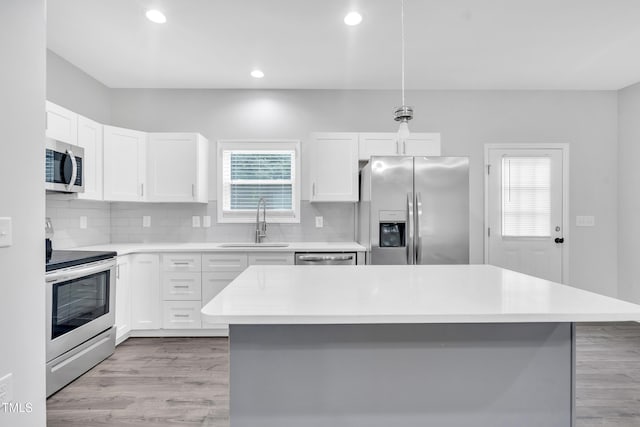 1213 Grant St, Durham, NC 27701 - kitchen featuring stainless steel appliances, decorative backsplash, light countertops, and recessed lighting