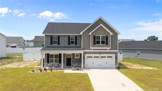 283 Leach Creek Dr, Raeford, NC 28376 - view of front facade with covered porch, concrete driveway, an attached garage, stone siding, and roof with shingles