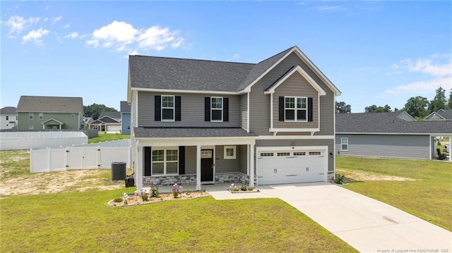 283 Leach Creek Dr, Raeford, NC 28376 - view of front facade with covered porch, driveway, an attached garage, stone siding, and a gate