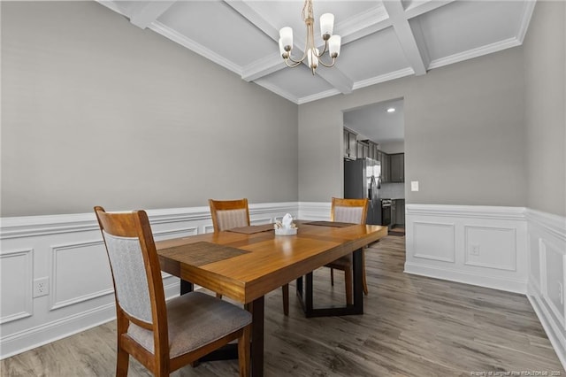 283 Leach Creek Dr, Raeford, NC 28376 - dining area featuring a chandelier, beam ceiling, wainscoting, a decorative wall, and wood finished floors