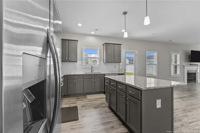 283 Leach Creek Dr, Raeford, NC 28376 - kitchen featuring freestanding refrigerator, gray cabinets, open floor plan, a center island, and light wood-style floors
