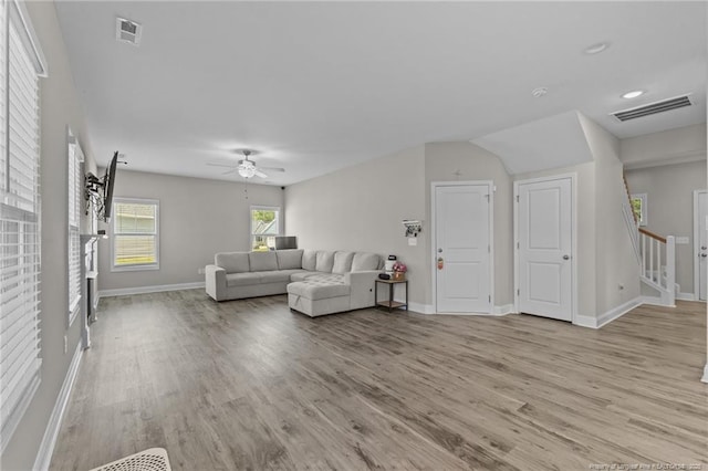 283 Leach Creek Dr, Raeford, NC 28376 - living area with light wood finished floors, a ceiling fan, and stairway