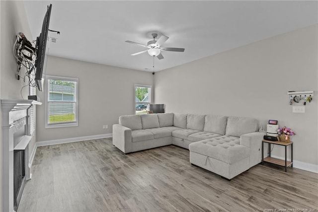 283 Leach Creek Dr, Raeford, NC 28376 - living room featuring a fireplace, a ceiling fan, and wood finished floors