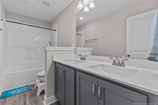 283 Leach Creek Dr, Raeford, NC 28376 - full bathroom with wood finished floors, double vanity, and shower / bath combination