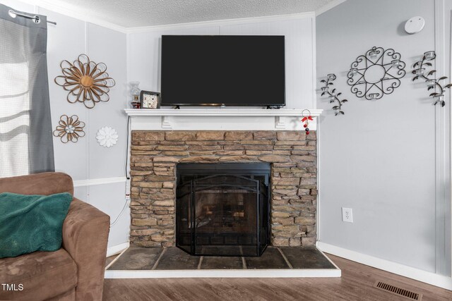 51 Brafford Estates Dr, Cameron, NC 28326 - detailed view of wood finished floors, crown molding, a stone fireplace, and a textured ceiling