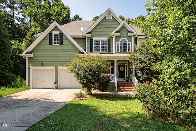 515 Wellingham Dr, Durham, NC 27713 - traditional-style home featuring driveway, covered porch, a front lawn, and an attached garage