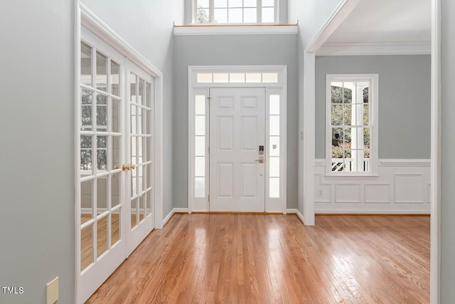 515 Wellingham Dr, Durham, NC 27713 - foyer with french doors, wood finished floors, crown molding, and wainscoting