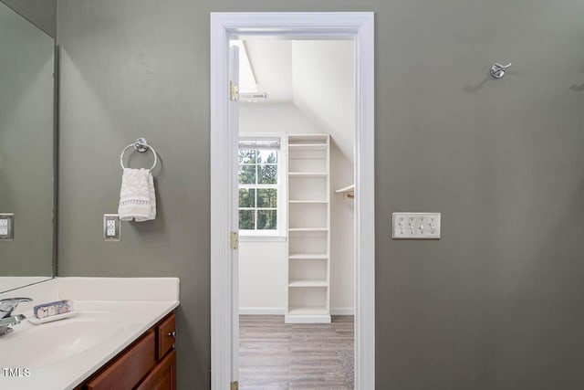 515 Wellingham Dr, Durham, NC 27713 - bathroom featuring wood finished floors, vanity, and vaulted ceiling