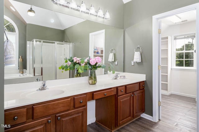 515 Wellingham Dr, Durham, NC 27713 - bathroom featuring a stall shower, healthy amount of natural light, double vanity, and wood finished floors