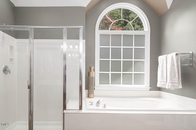 515 Wellingham Dr, Durham, NC 27713 - full bathroom with a stall shower, a garden tub, and vaulted ceiling