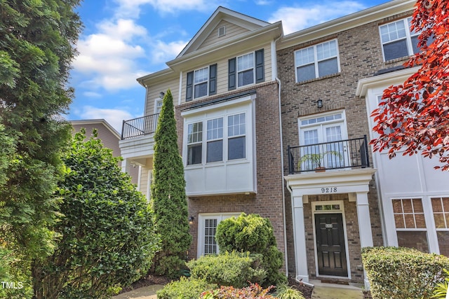 9216 Wooden Rd, Raleigh, NC 27617 - view of front facade with a balcony and brick siding