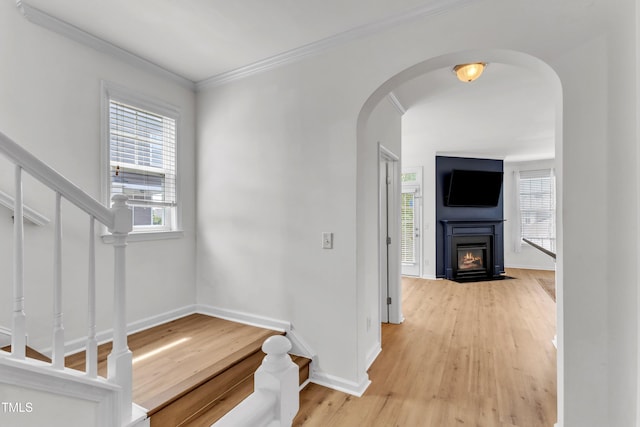 9216 Wooden Rd, Raleigh, NC 27617 - hallway featuring plenty of natural light, light wood-style floors, arched walkways, ornamental molding, and stairs