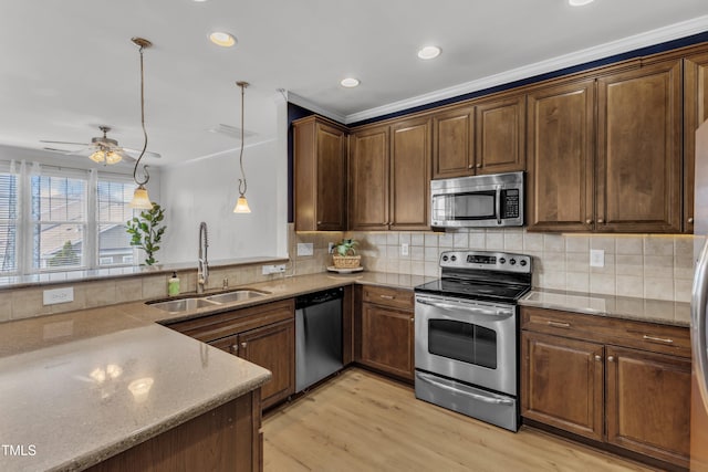 9216 Wooden Rd, Raleigh, NC 27617 - kitchen with appliances with stainless steel finishes, light wood-style floors, ornamental molding, light stone countertops, and decorative backsplash