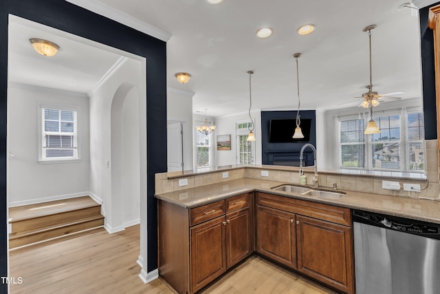 9216 Wooden Rd, Raleigh, NC 27617 - kitchen featuring dishwasher, crown molding, backsplash, arched walkways, and light wood-style floors