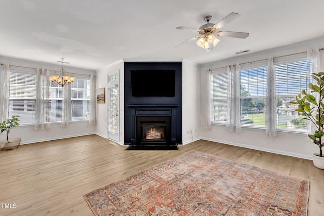 9216 Wooden Rd, Raleigh, NC 27617 - unfurnished living room with a chandelier, wood finished floors, a fireplace, ceiling fan, and crown molding