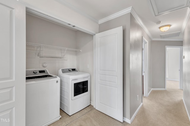 9216 Wooden Rd, Raleigh, NC 27617 - laundry room featuring washing machine and dryer, crown molding, attic access, and light carpet