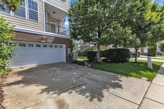 9216 Wooden Rd, Raleigh, NC 27617 - view of side of property featuring a balcony, a garage, concrete driveway, a yard, and brick siding