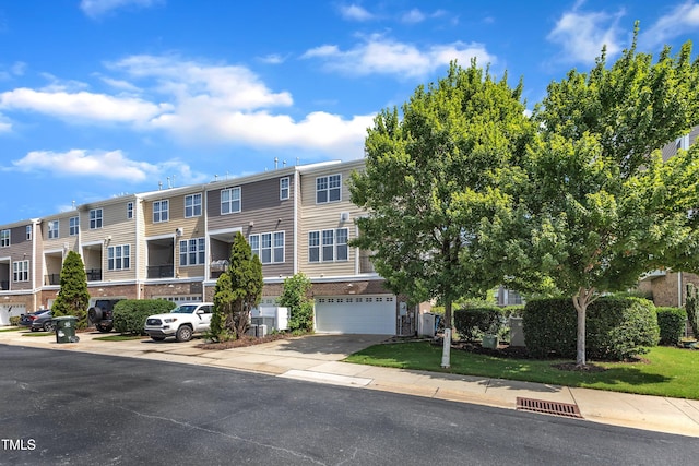 9216 Wooden Rd, Raleigh, NC 27617 - view of building exterior featuring a garage and a residential view