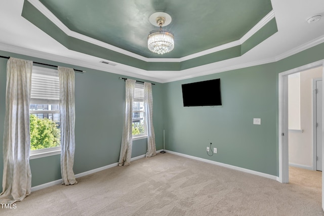 9216 Wooden Rd, Raleigh, NC 27617 - spare room featuring a tray ceiling, carpet floors, crown molding, a chandelier, and a smoke detector