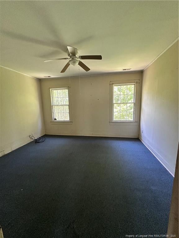 410 W K St, Erwin, NC 28339 - empty room featuring healthy amount of natural light, a ceiling fan, and carpet floors