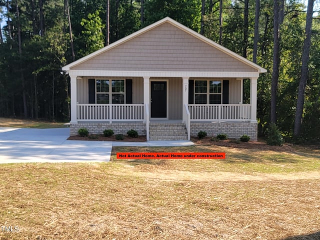307 E Holmes St, Benson, NC 27504 - bungalow-style home featuring covered porch and board and batten siding