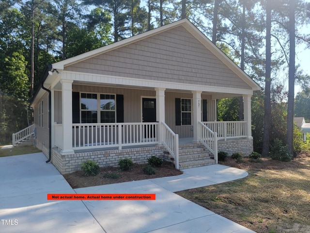 307 E Holmes St, Benson, NC 27504 - view of front of house featuring a porch and board and batten siding