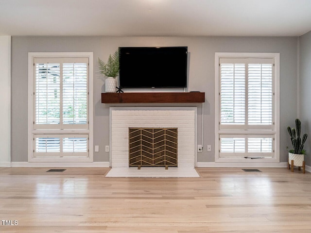 3205 Dell Dr, Raleigh, NC 27609 - unfurnished living room with wood finished floors and a fireplace