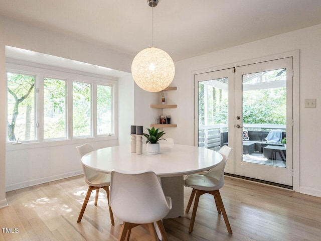 3205 Dell Dr, Raleigh, NC 27609 - dining space with french doors, light wood finished floors, and plenty of natural light