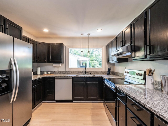 3205 Dell Dr, Raleigh, NC 27609 - kitchen with appliances with stainless steel finishes, ventilation hood, pendant lighting, dark cabinets, and recessed lighting