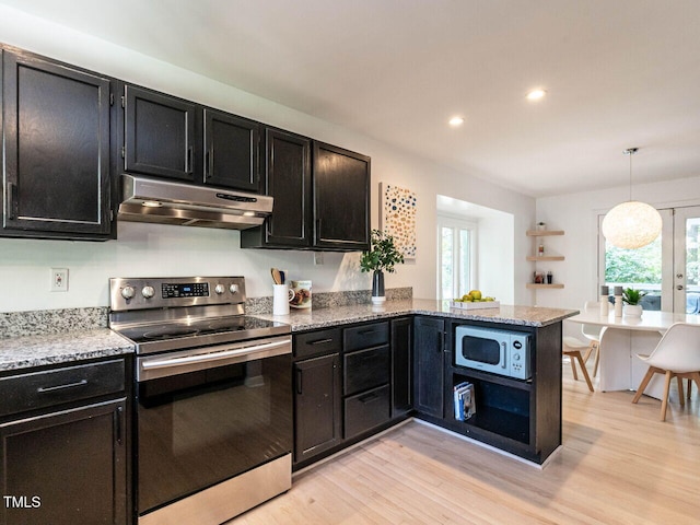 3205 Dell Dr, Raleigh, NC 27609 - kitchen with stainless steel appliances, under cabinet range hood, dark cabinets, light wood-style floors, and healthy amount of natural light